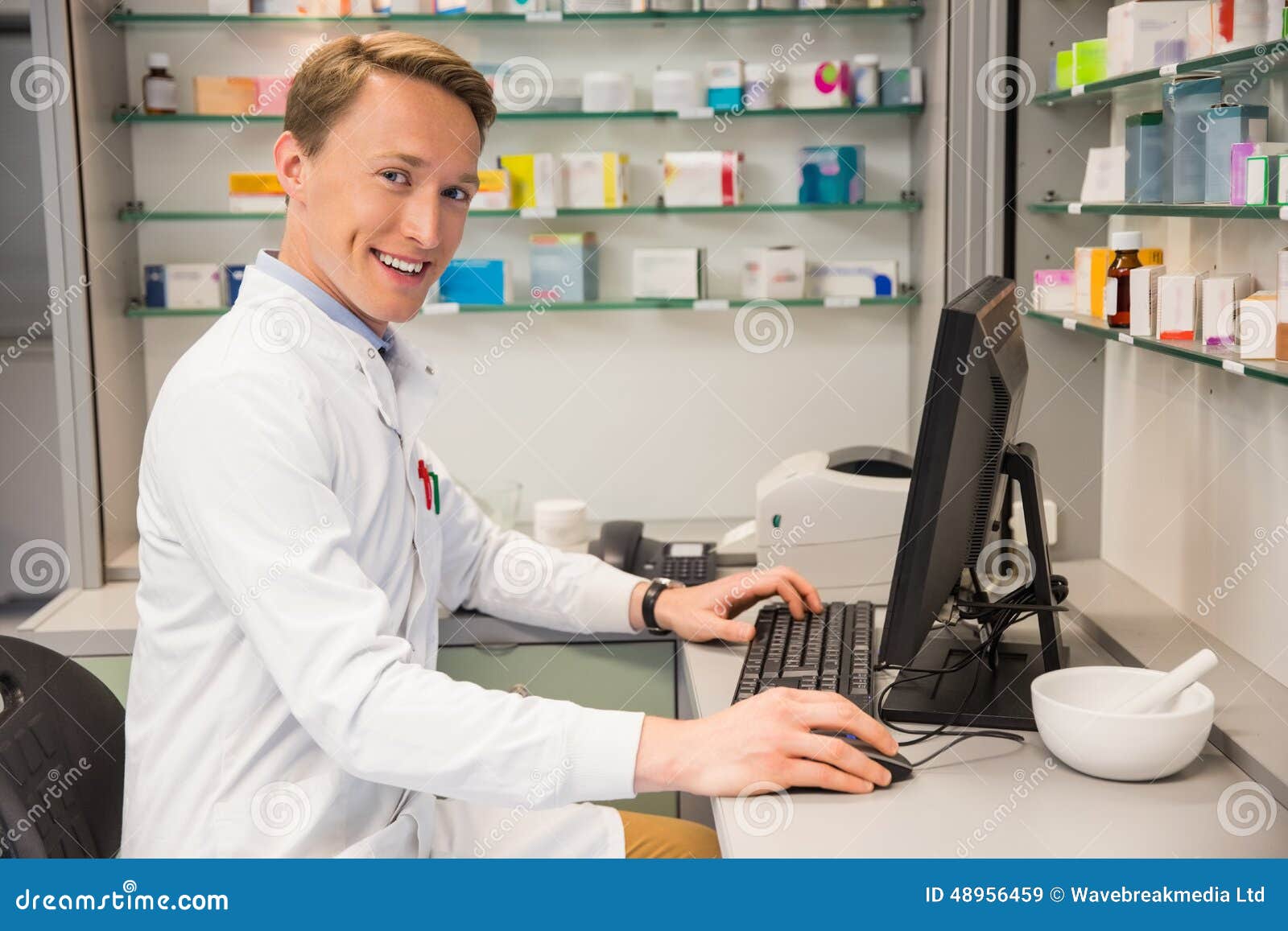 Handsome Pharmacist Using the Computer Stock Image Image of treatment