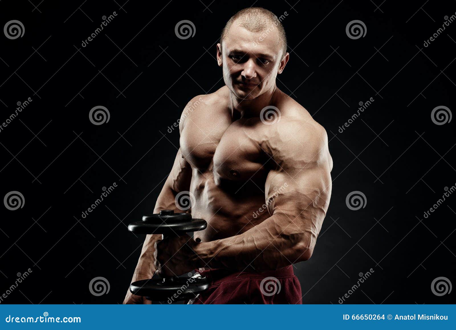 Handsome Power Athletic Man in Training Pumping Up Muscles with Stock ...