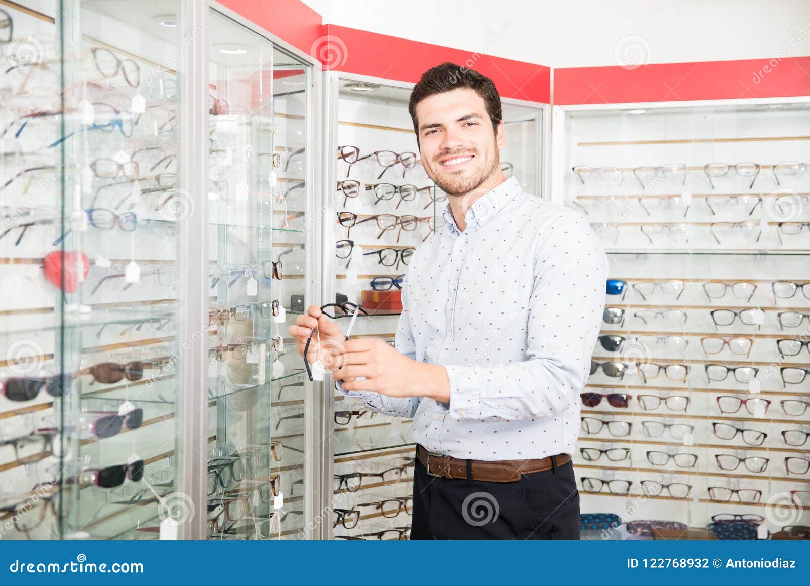 Cheerful Young Man Buying New Spectacles in Optical Store Stock Photo ...