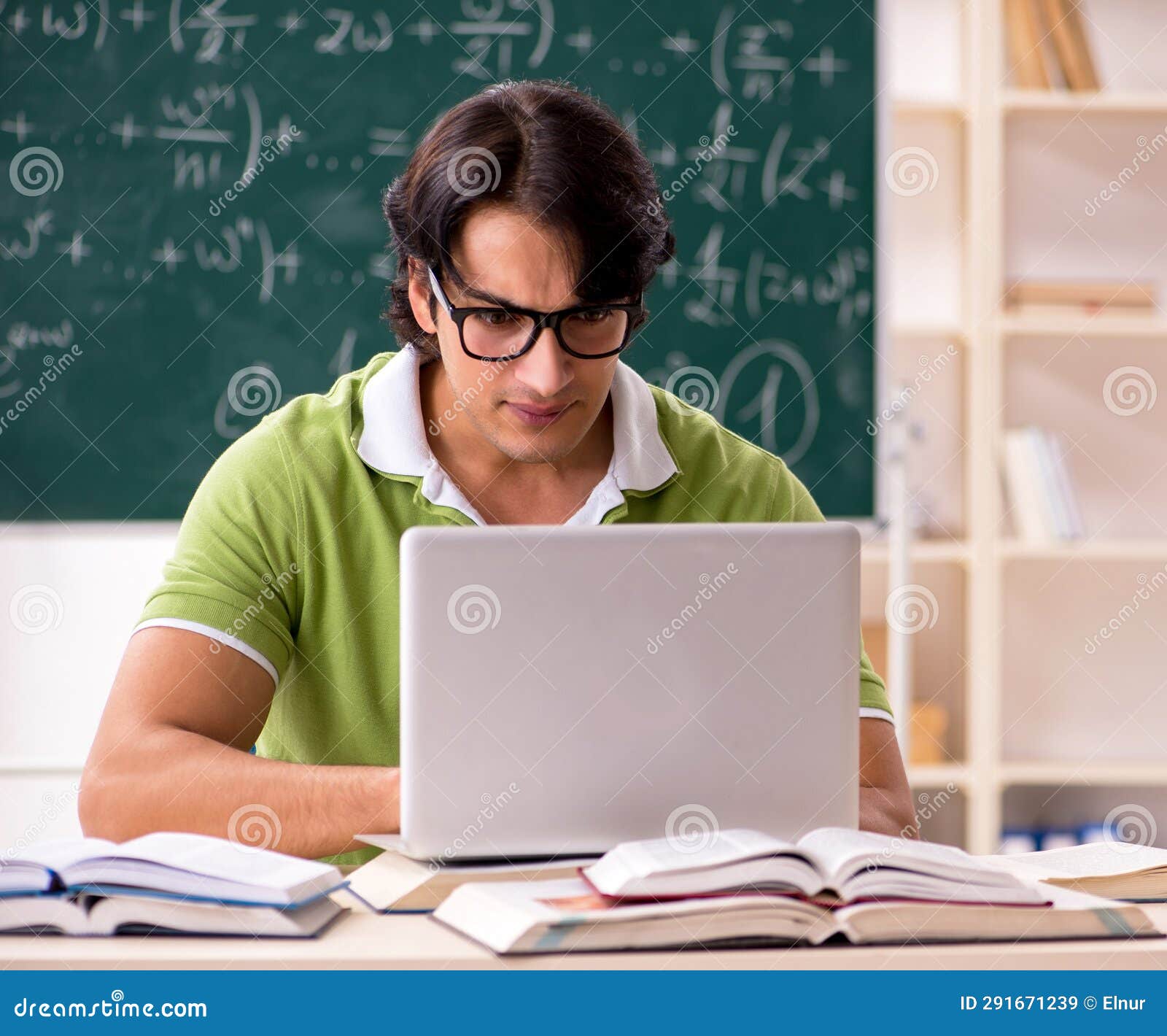 Handsome Student in Front of Chalkboard with Formulas Stock Image