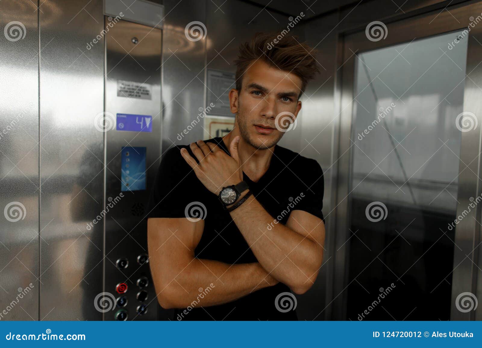 Handsome Stylish Man with a Haircut in a Black T-shirt Stock Photo