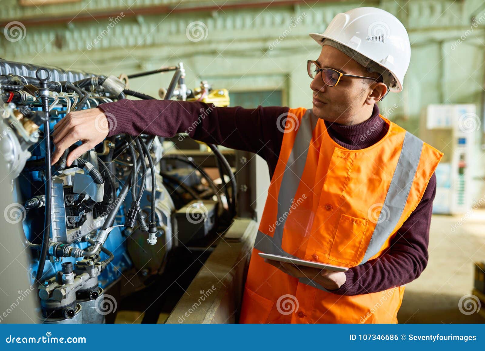 handsome technician adjusting engine features