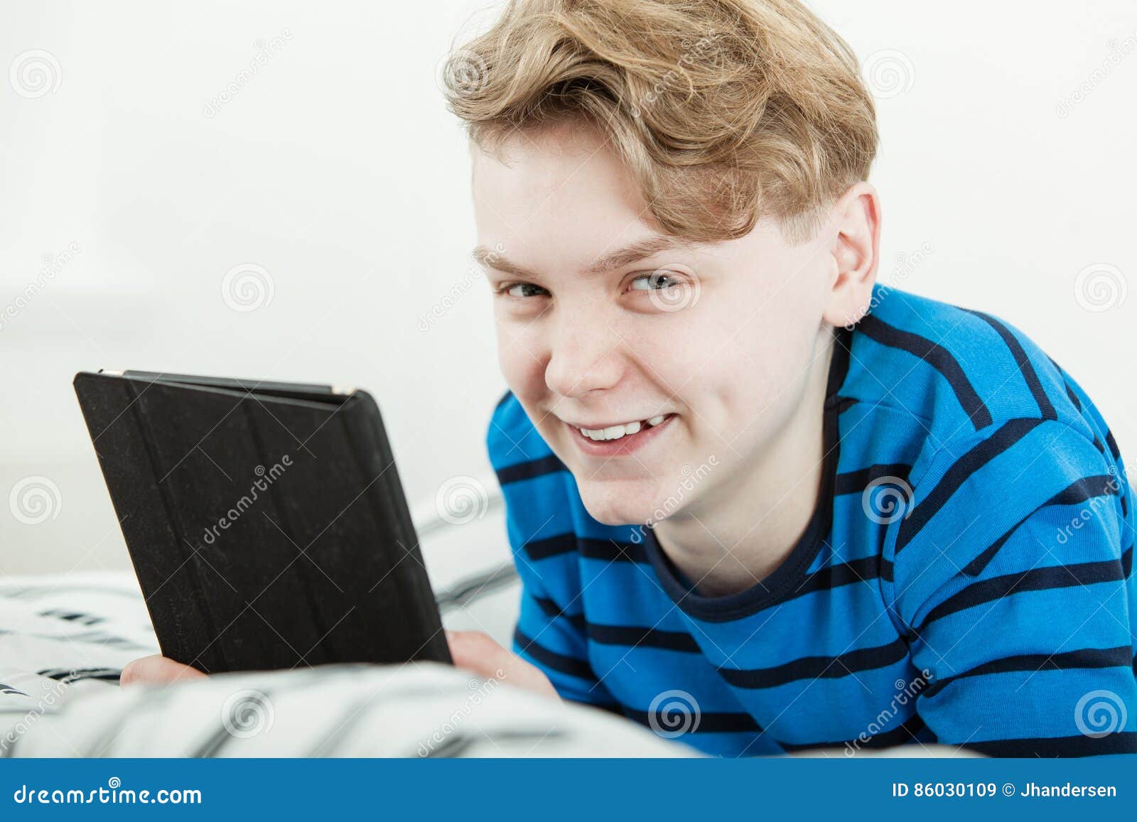 Handsome Teenage Boy with a Happy Grin Stock Image - Image of tablet ...