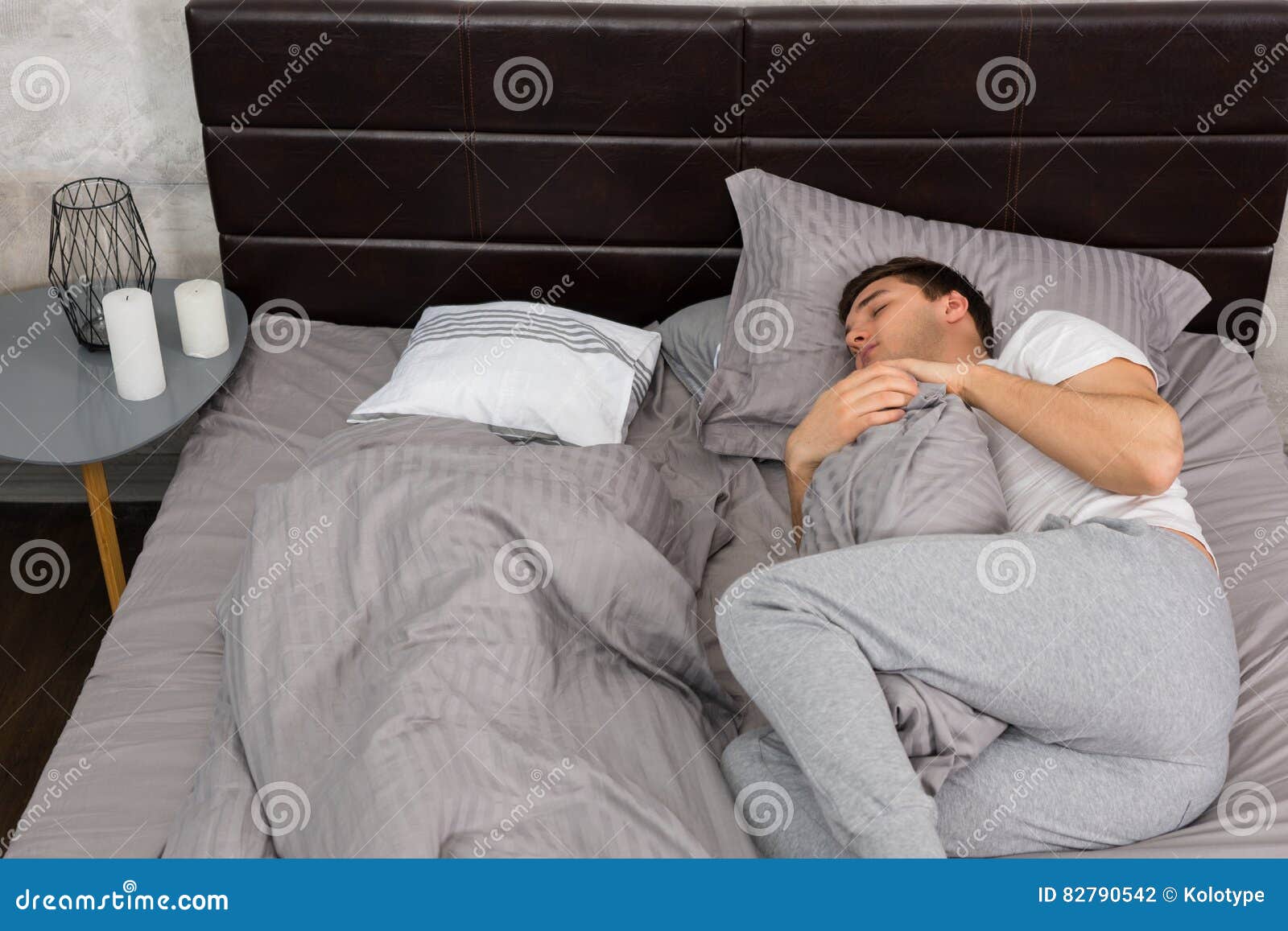 Handsome Tired Male in Pajama Sleeping Alone without Blanket and Stock ...