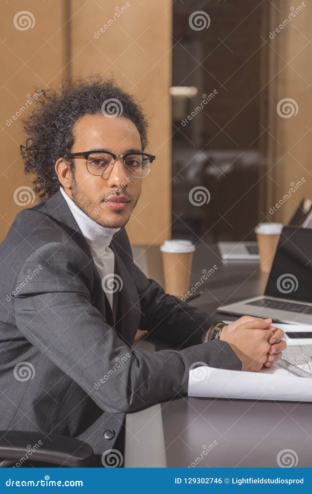 Handsome Young Architect in Suit Sitting at Workplace Stock Photo