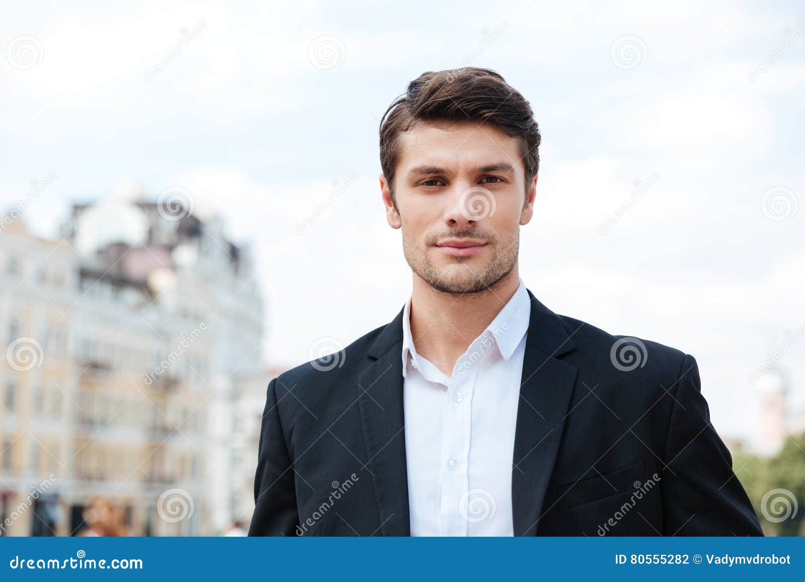 Handsome Young Businessman in Suit Standing Outdoors Stock Photo