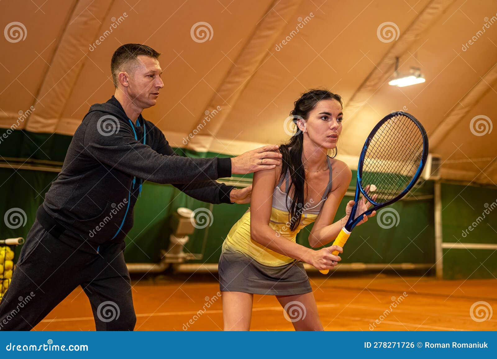 Handsome Young Coach Trains a Woman Who Came To Play Tennis. Stock