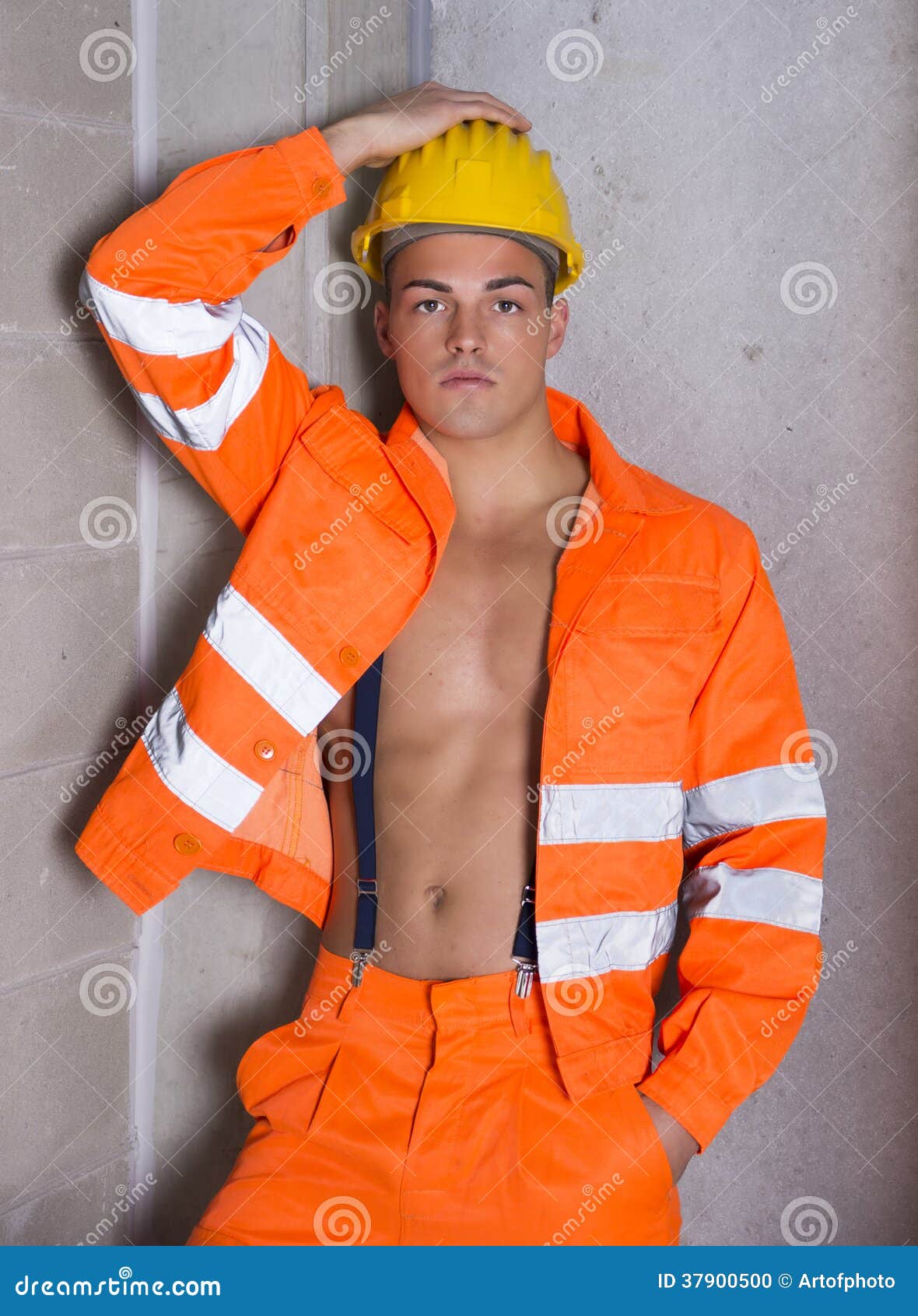Handsome Young Construction Worker with Orange Suit Open on Naked Torso