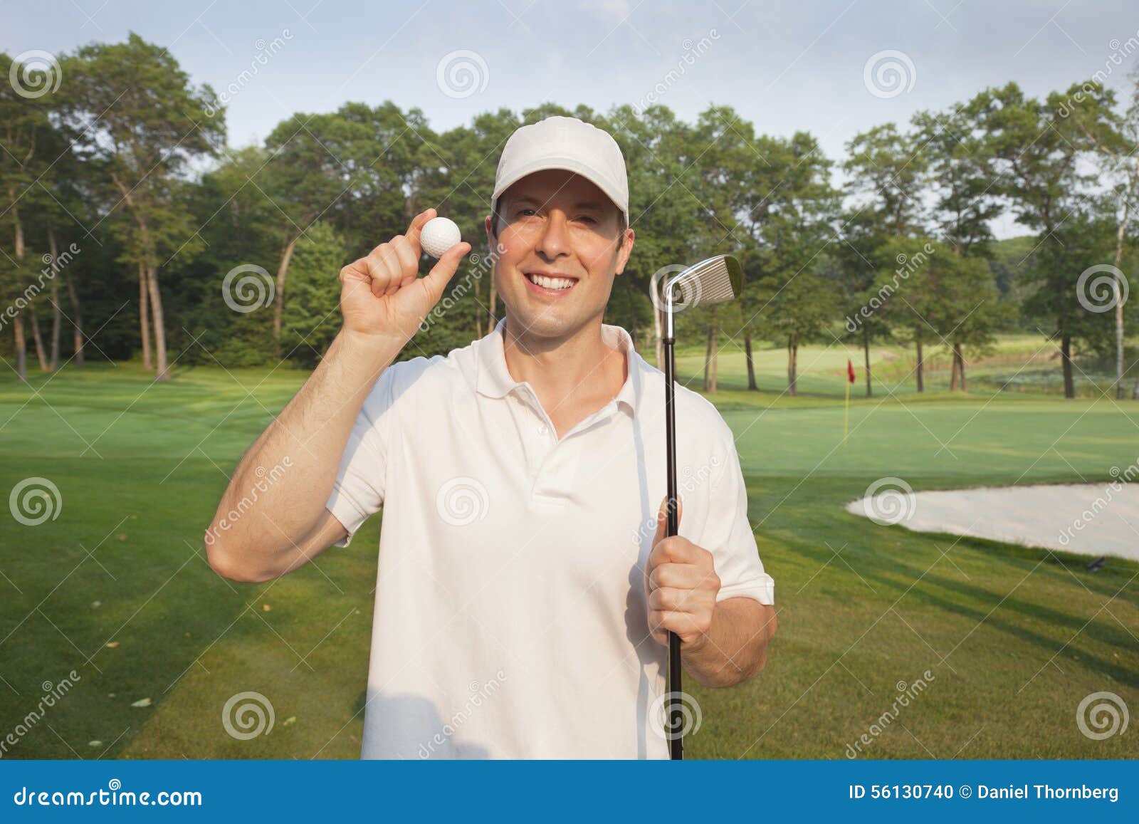 Handsome Young Golfer Holds Club and Ball on a Course Stock Photo ...