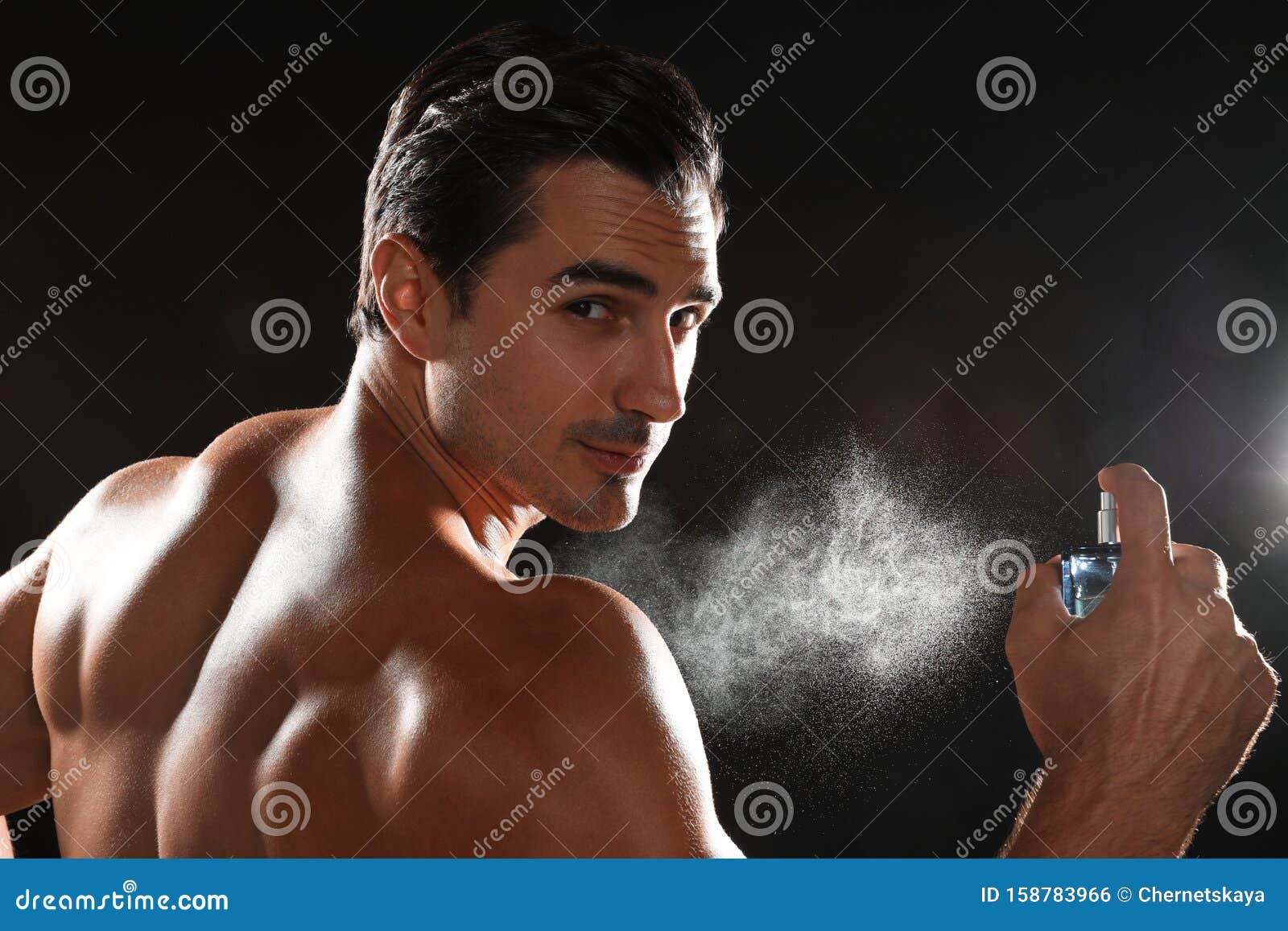 Handsome Young Man Applying Perfume on Background Stock Photo - Image ...