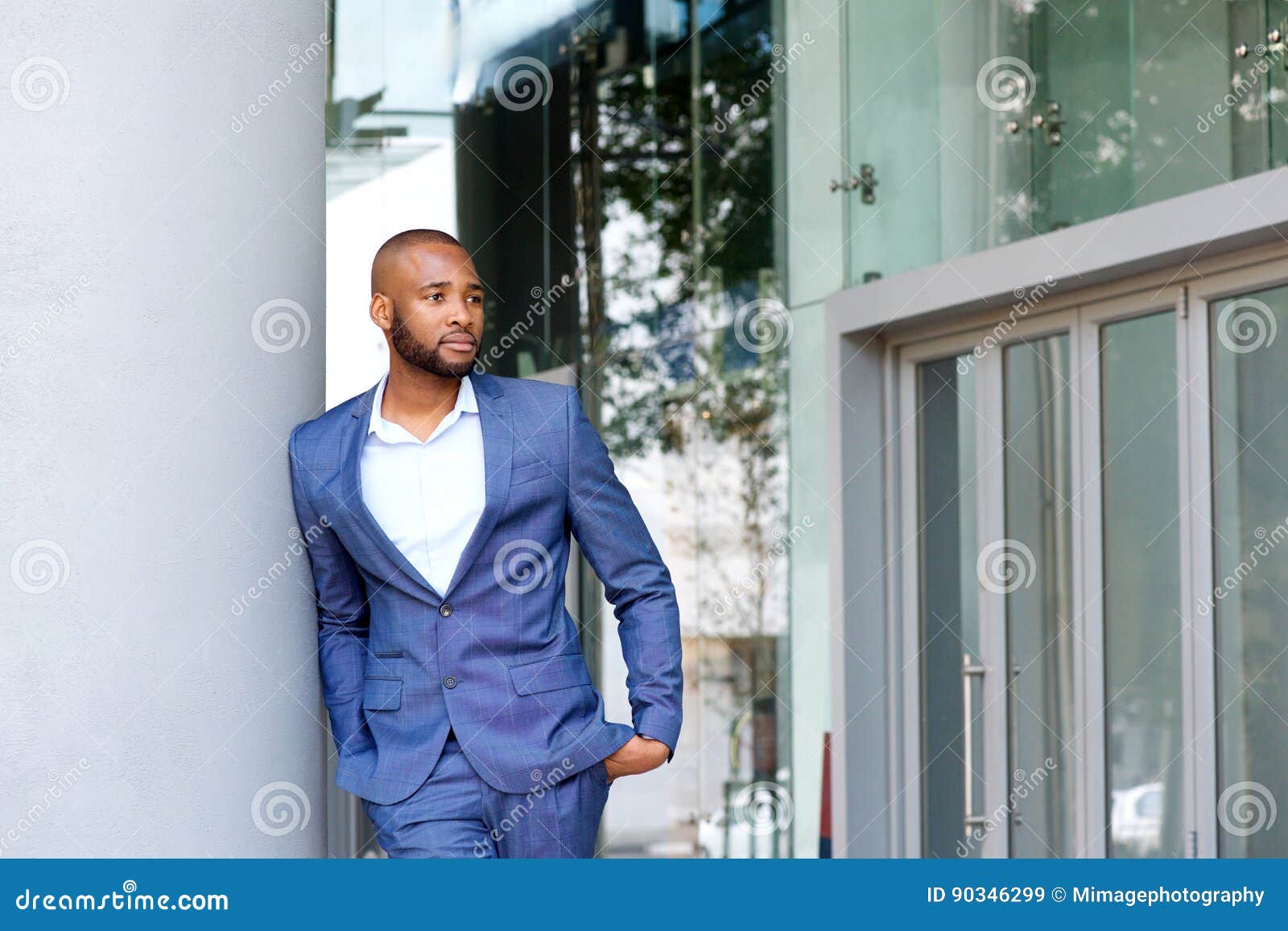 Handsome Young Man in Business Suit Leaning Against Wall Outdoors Stock ...