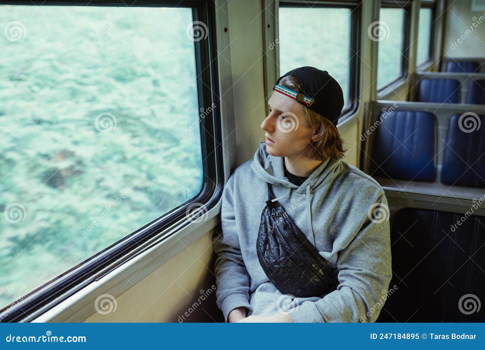 Young man looking out of train window on the historic steam engine