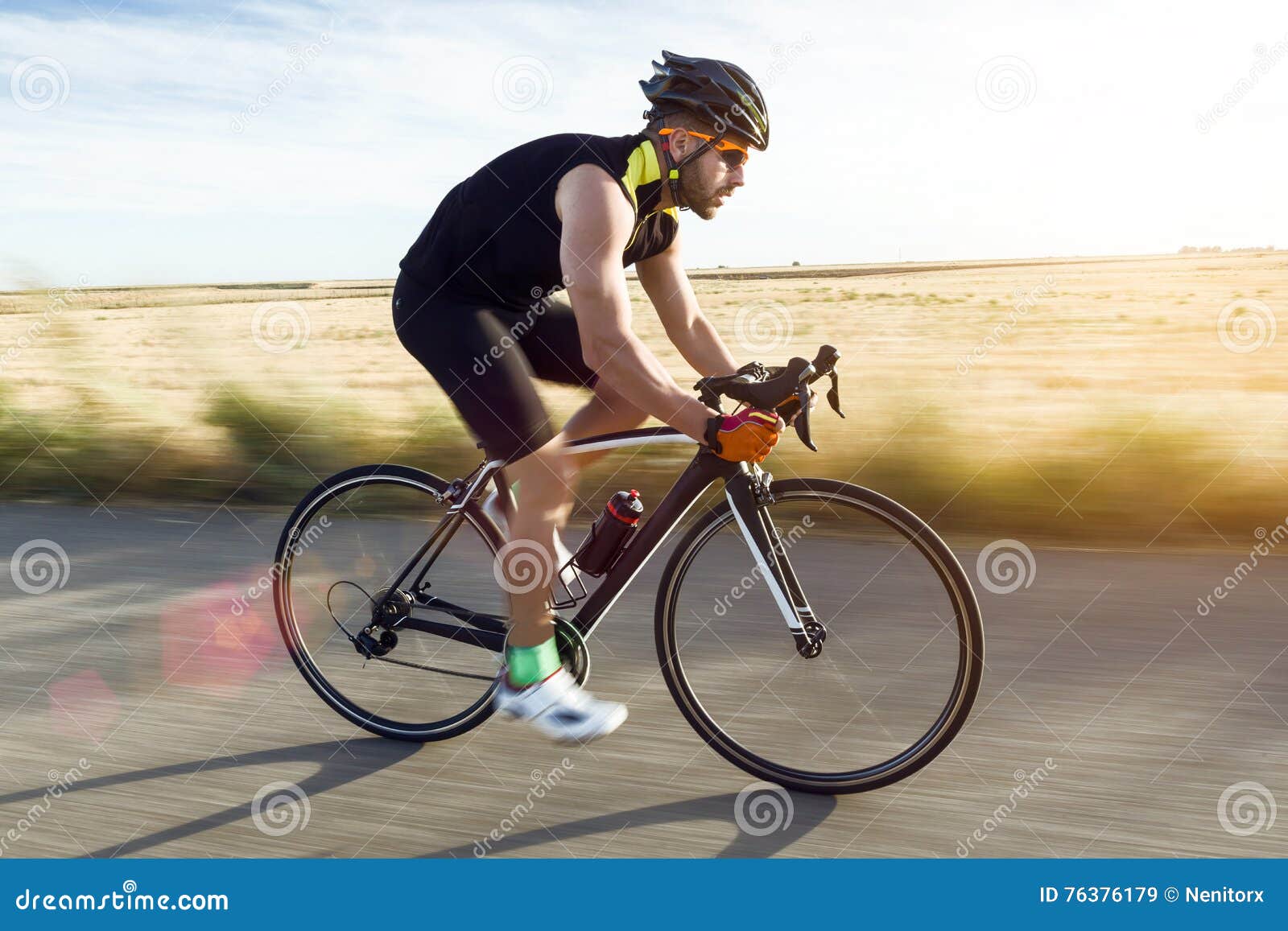 handsome young man cycling on the road.