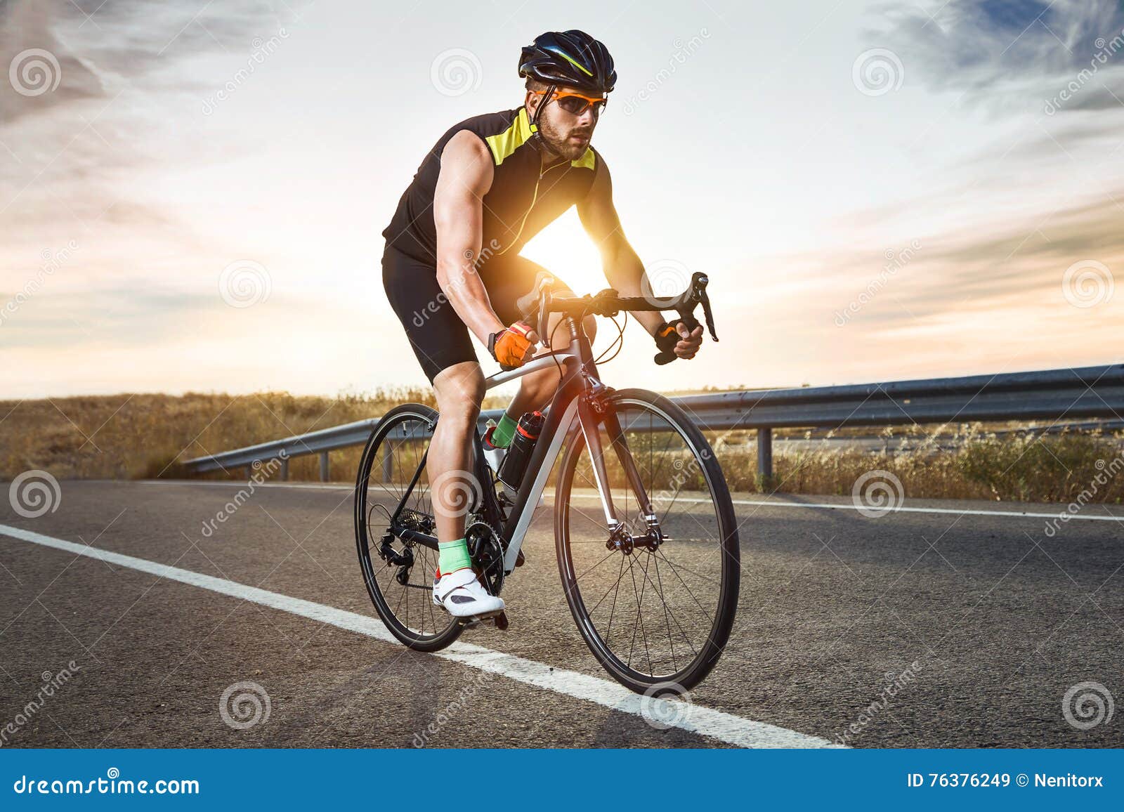 handsome young man cycling on the road.