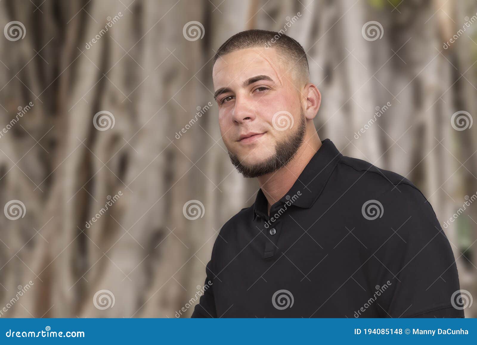 handsome young man deep scar above his eye looks camera neatly trimmed chin chair matched military style buzz cut 194085148