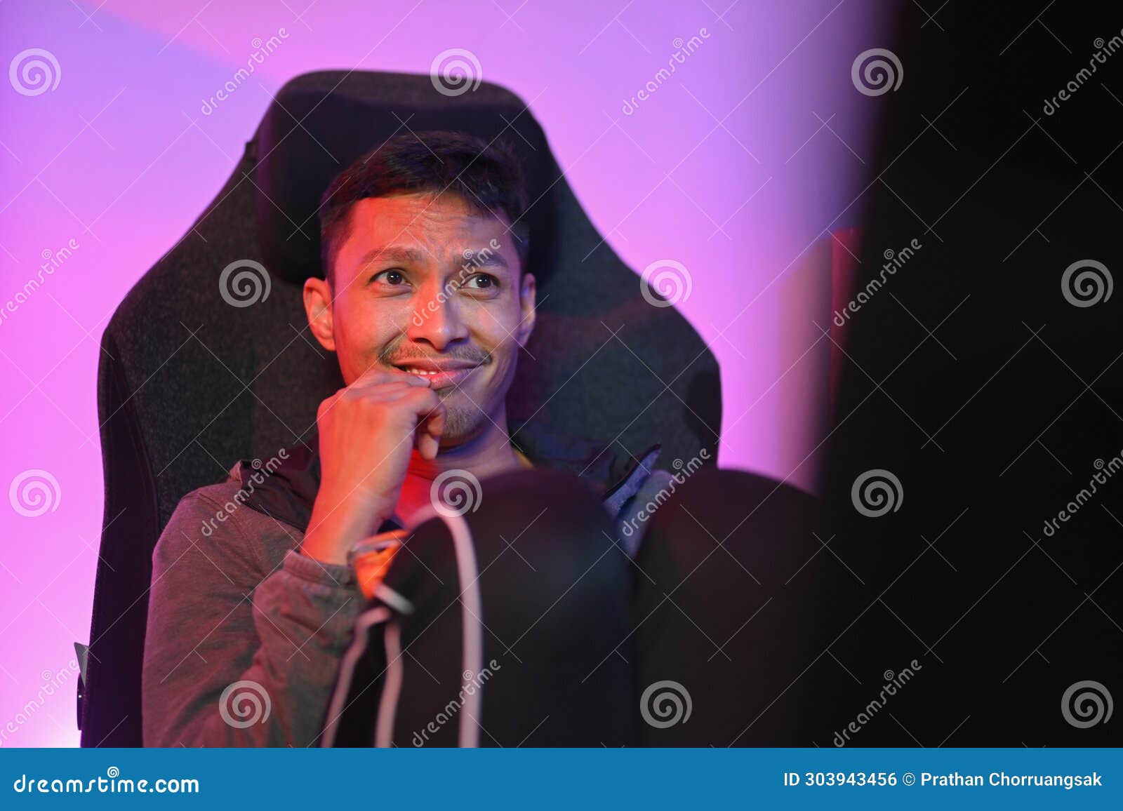 Handsome Young Man Eating Popcorn and Watching a Movie on Computer at