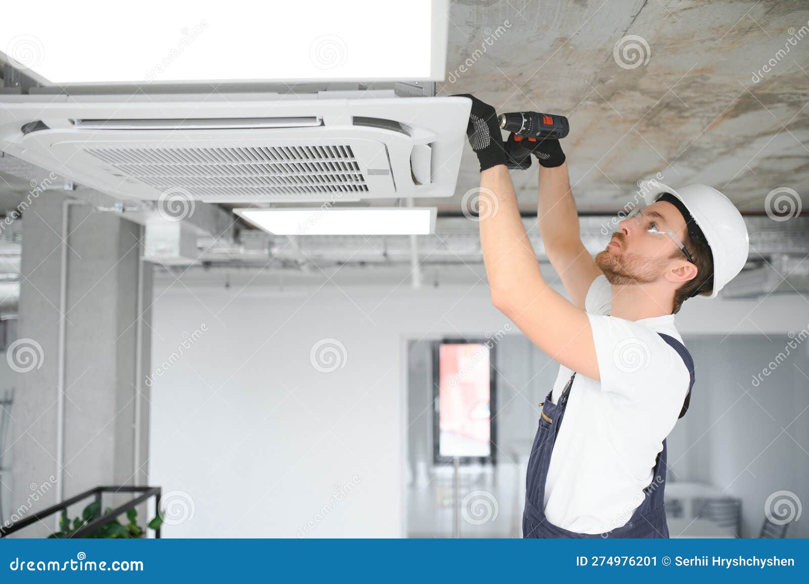 Handsome Young Man Electrician Installing Air Conditioning. Stock Image