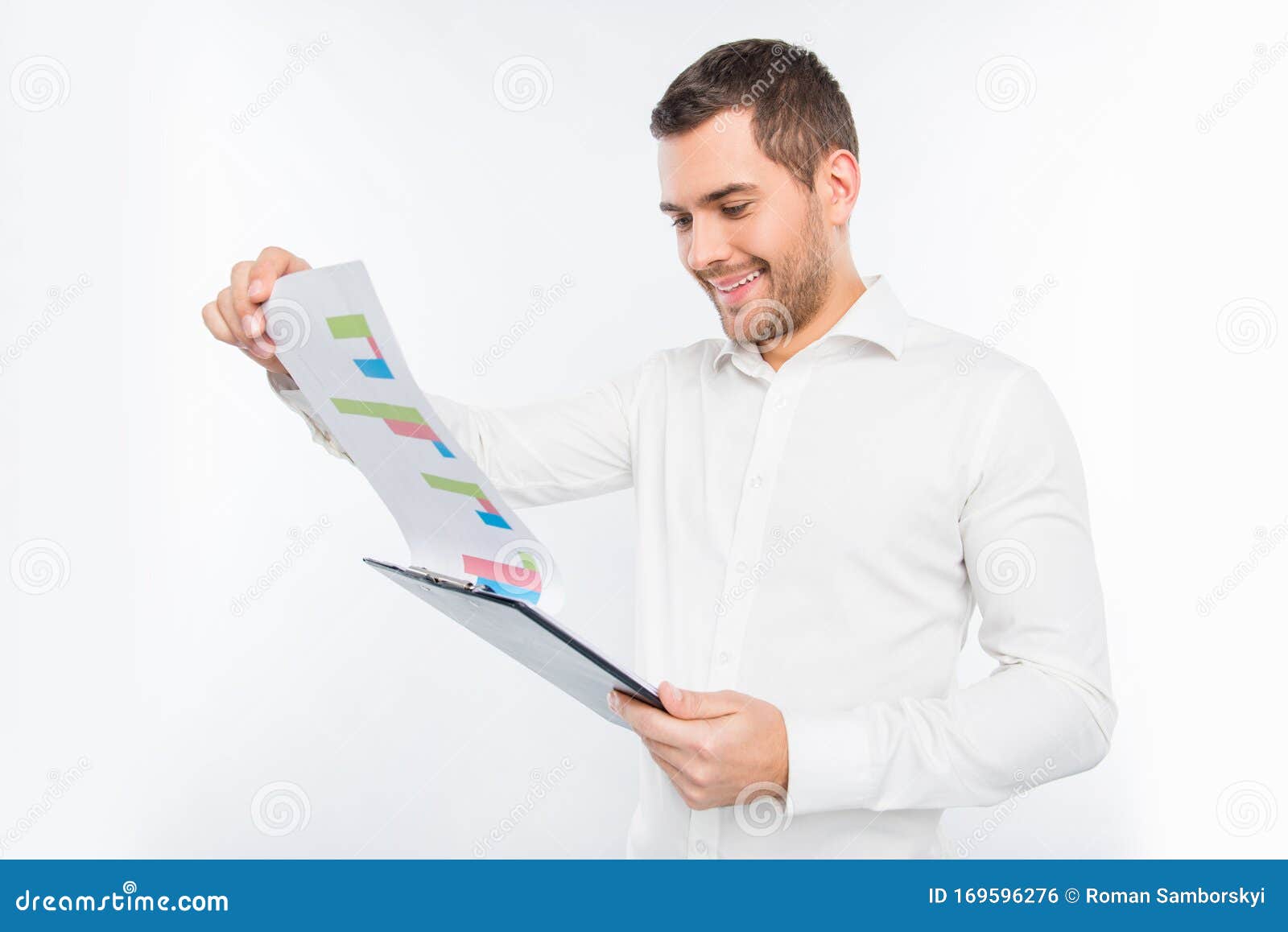 handsome young man holding a folder and looking at the diagrama