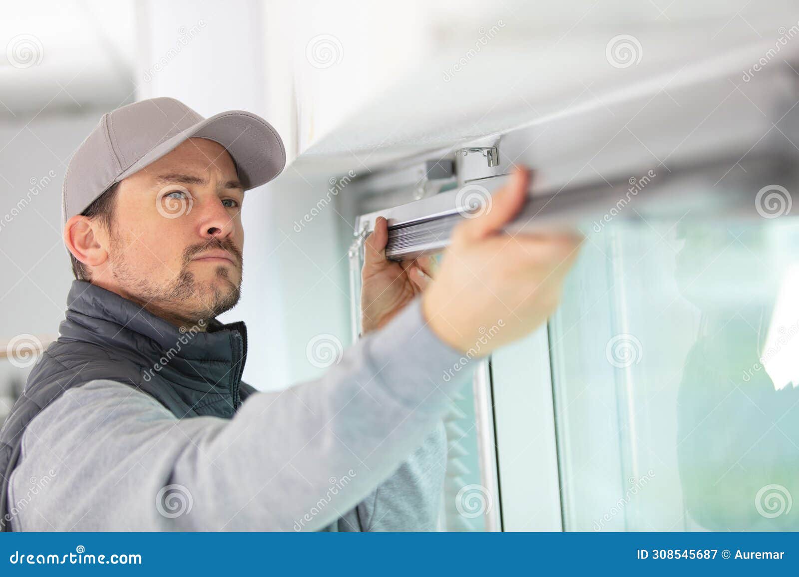 handsome young man installing bay window
