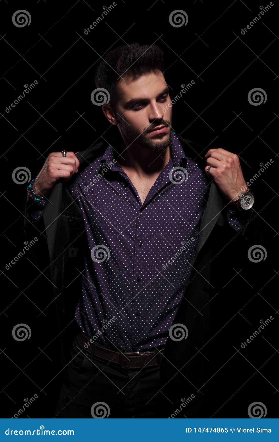 Handsome Young Man Looking Sideways And Fixing His Jacket Stock Image ...