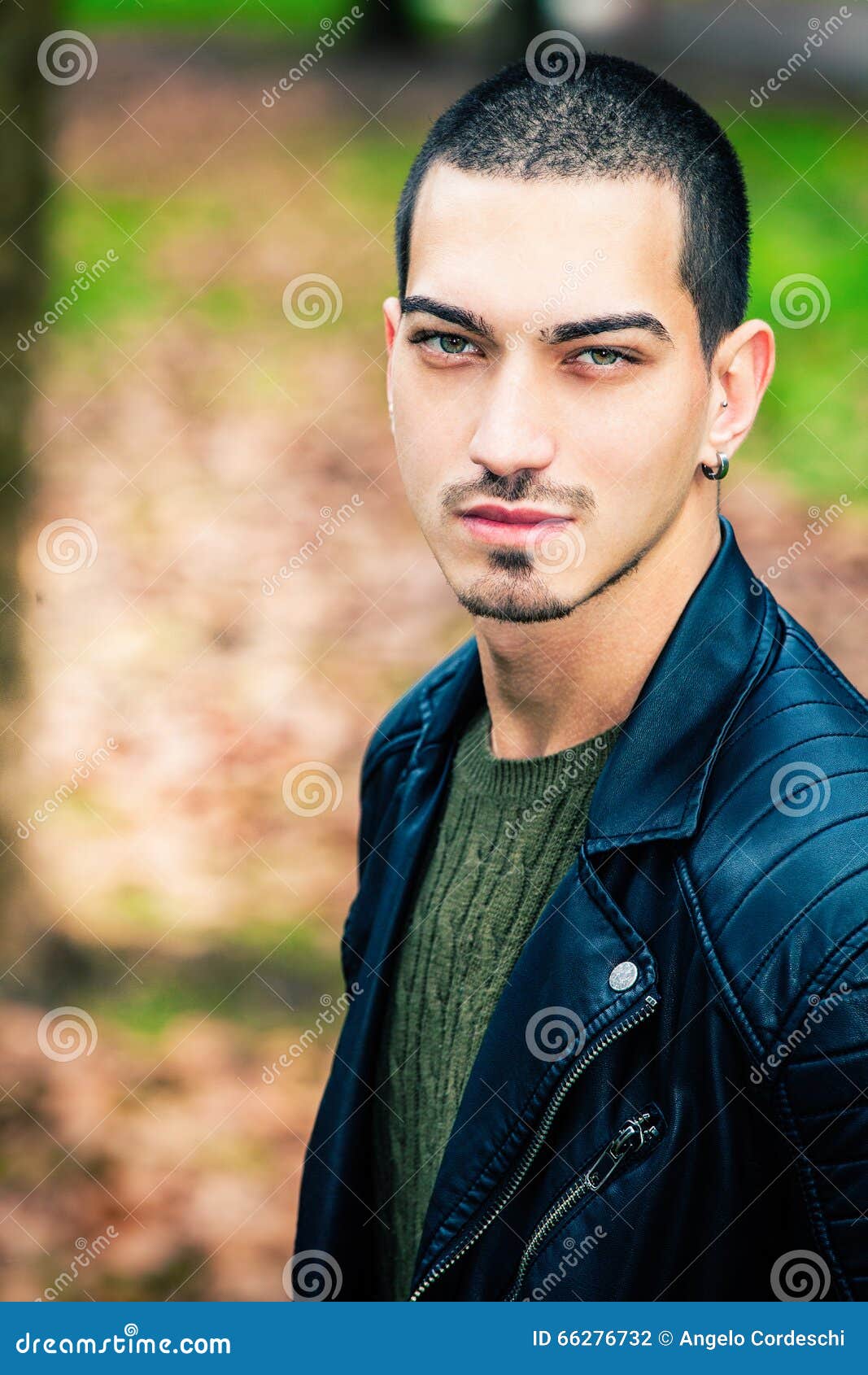 Close up portrait of a handsome young man with short hair and beard looking  away Stock Photo - Alamy