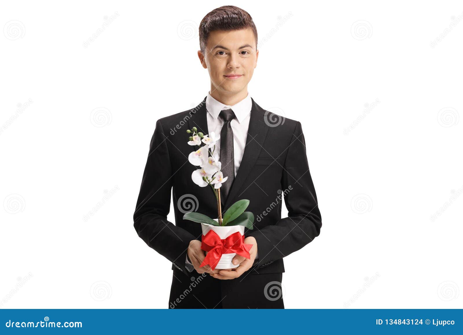Handsome Young Man in a Suit Holding an Orchid Flower Stock Photo ...