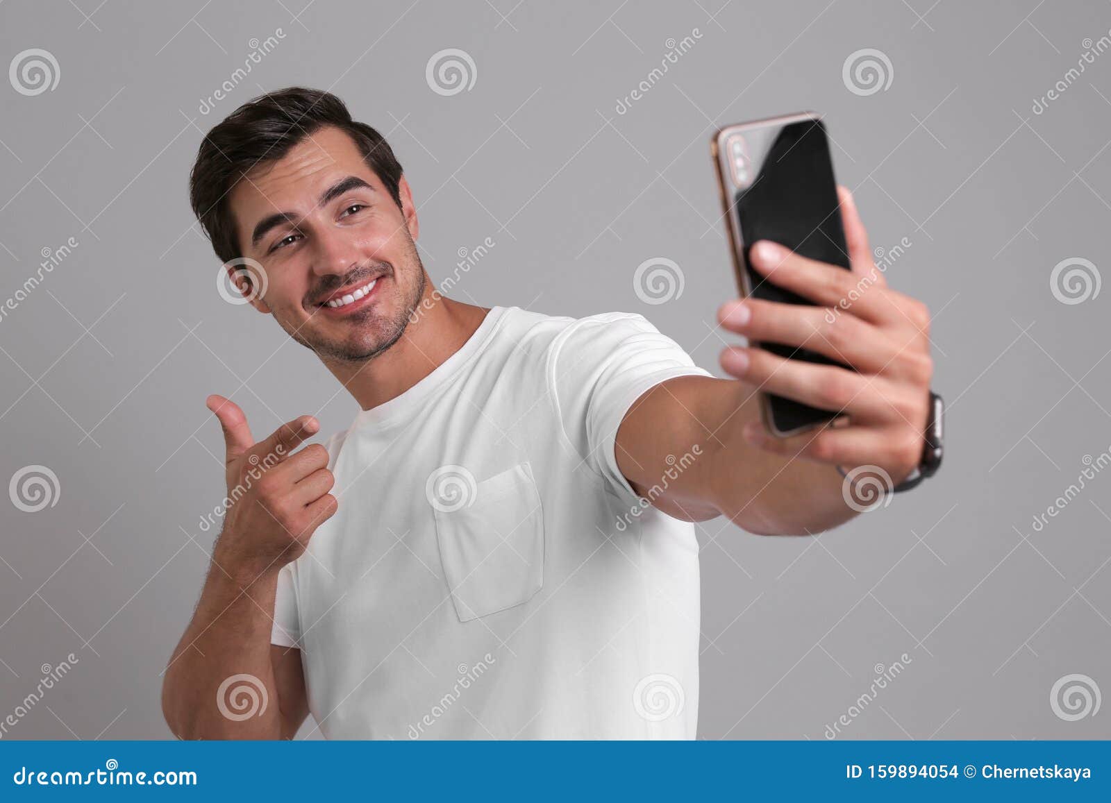 Handsome Young Man Taking Selfie with Smartphone on Background Stock ...