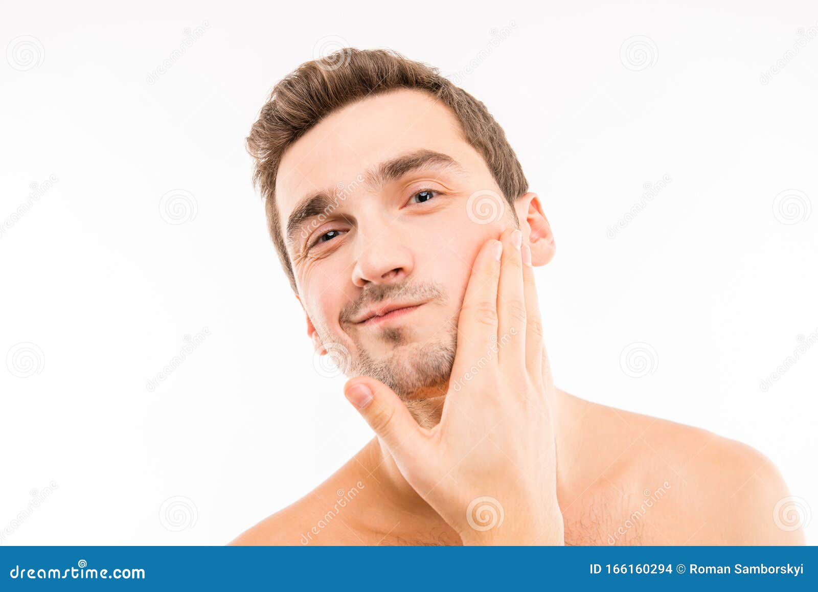 handsome young man touching his face after shave