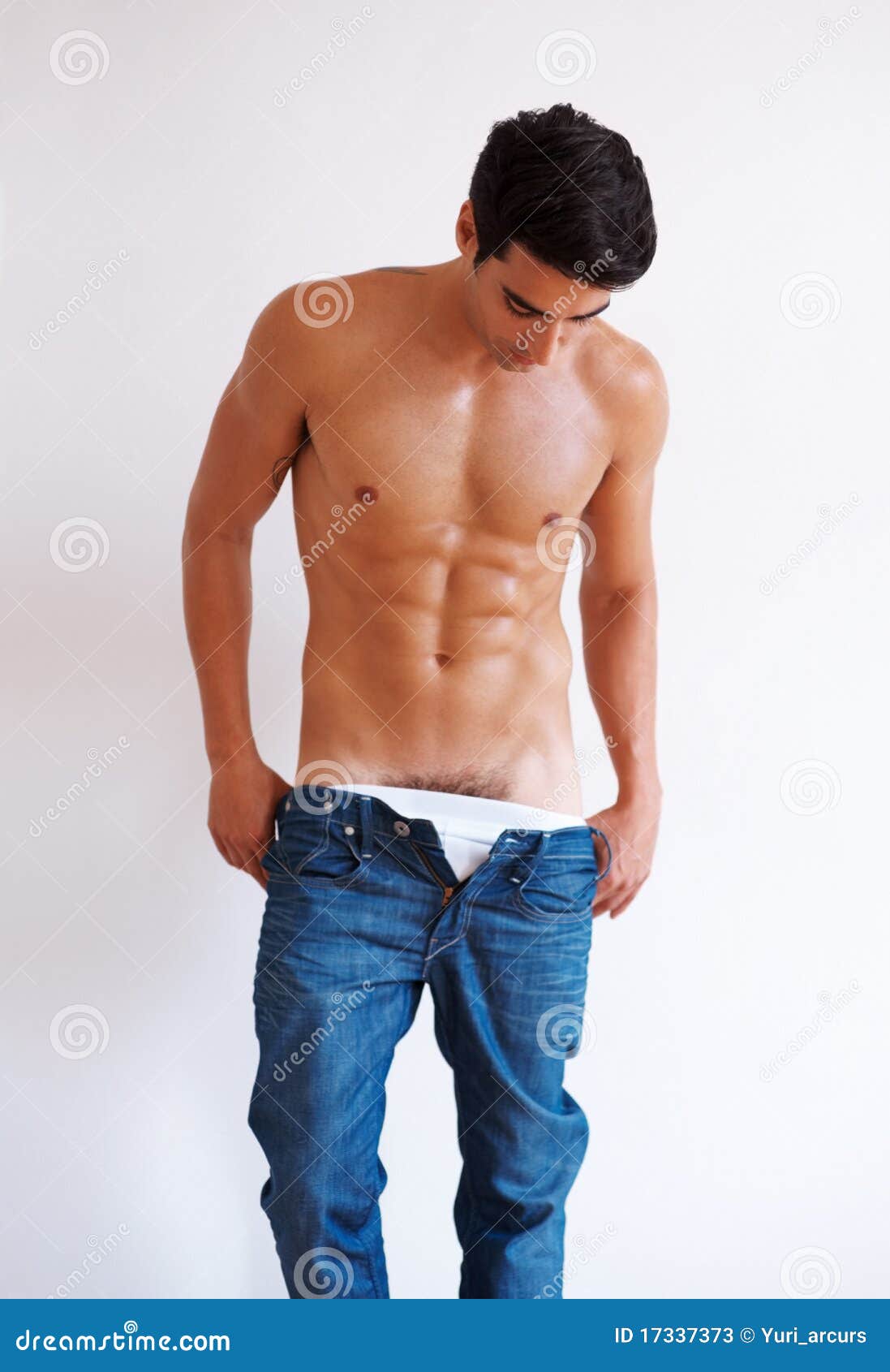 Stock Photos: Handsome young man undressing his clothes. Image: 17337373