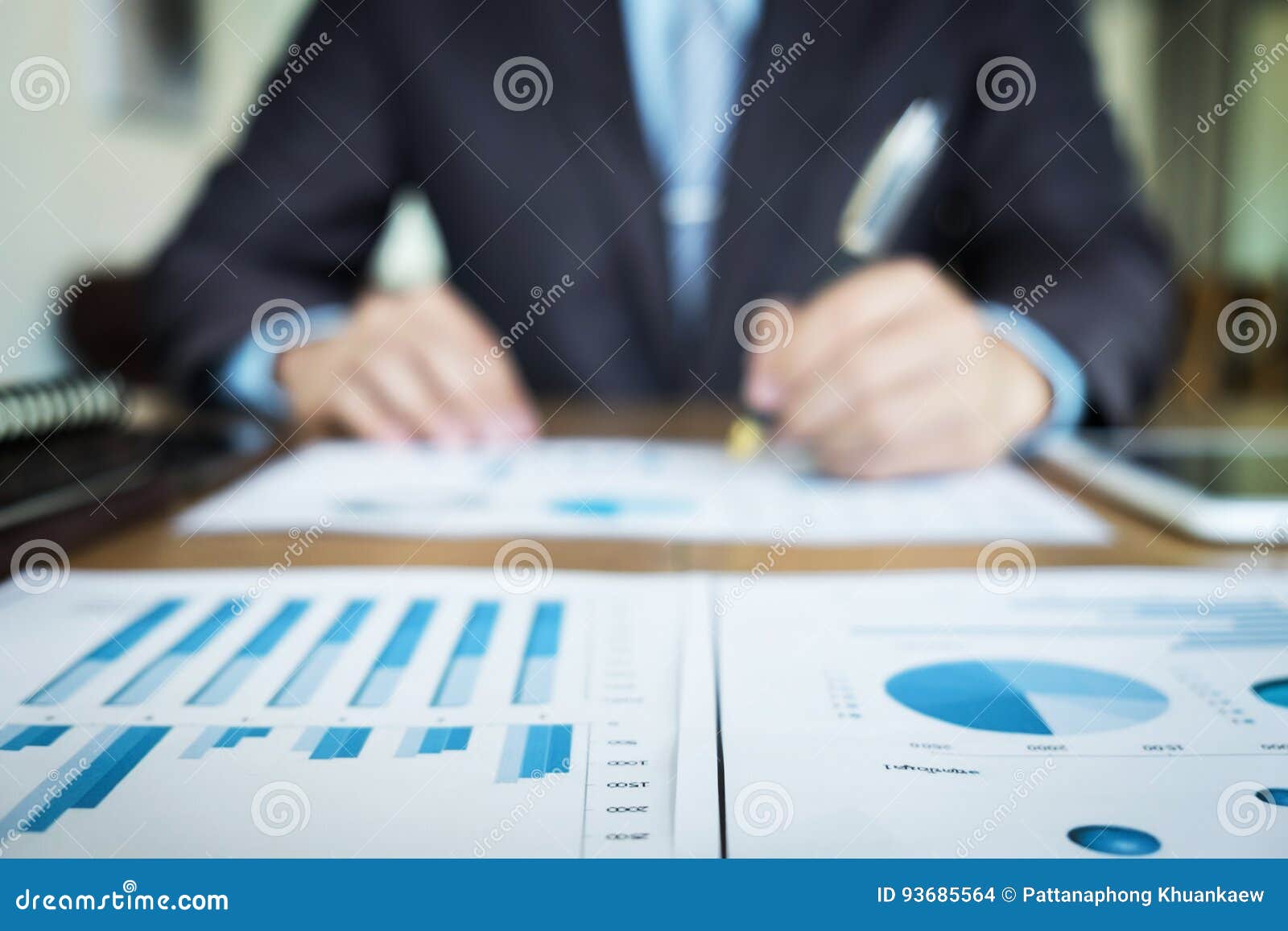 handsome young man working with touchpad while sitting on the co