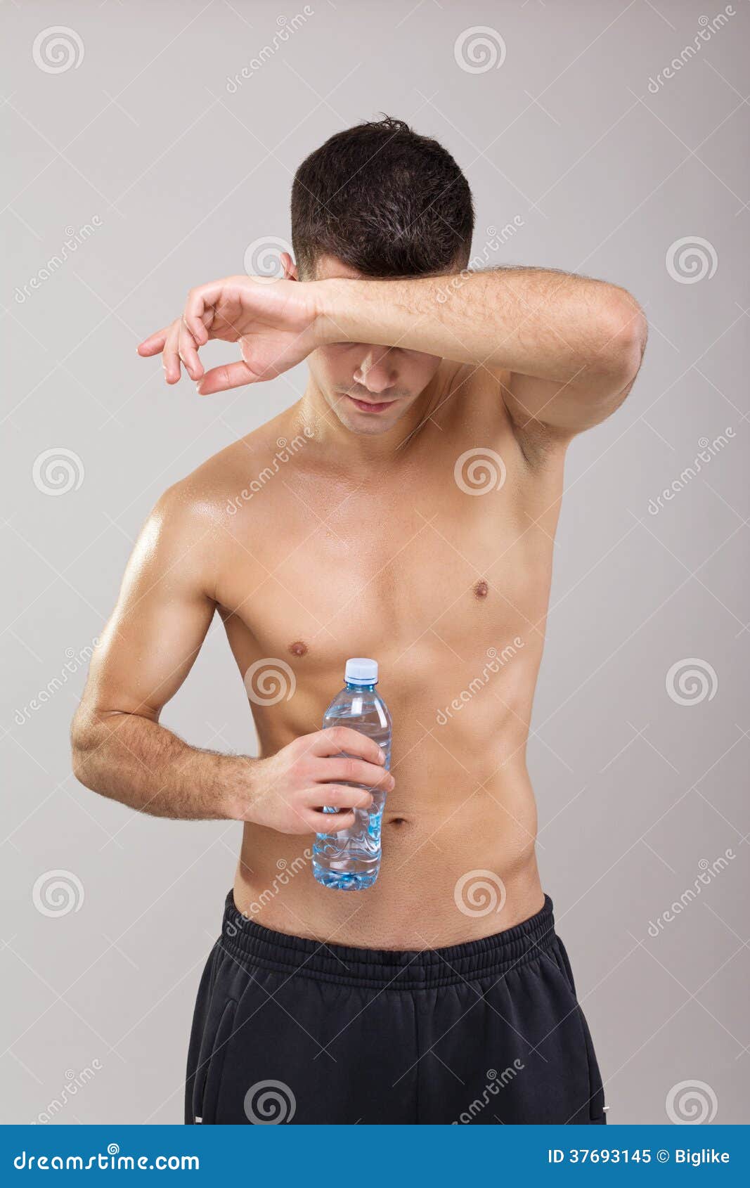 Handsome Young Tired Guy Drinking Water during Workout Stock Image
