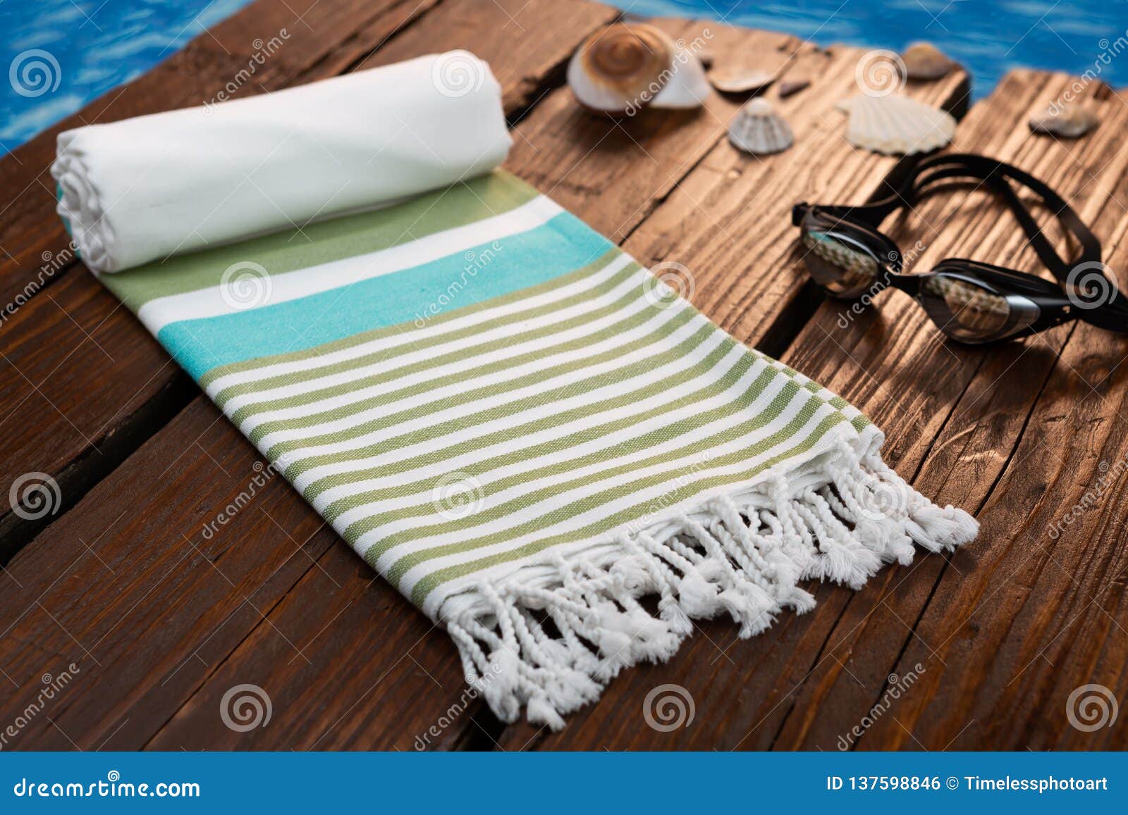 handwoven blue hammam turkish cotton towel on dark wooden bridge