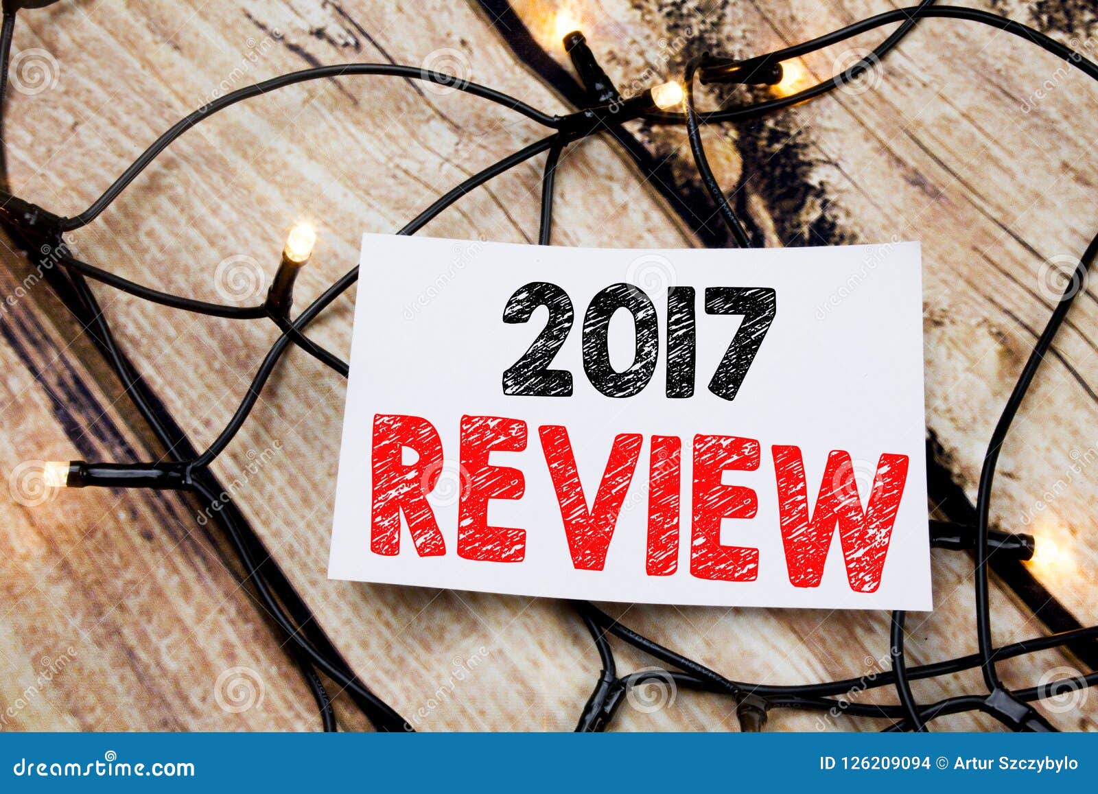 handwritten text caption showing 2017 review. business concept writing for annual summary report written on sticky note paper on t