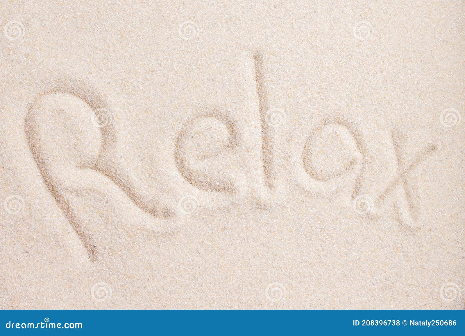 handwritting word relax in sand above view macro