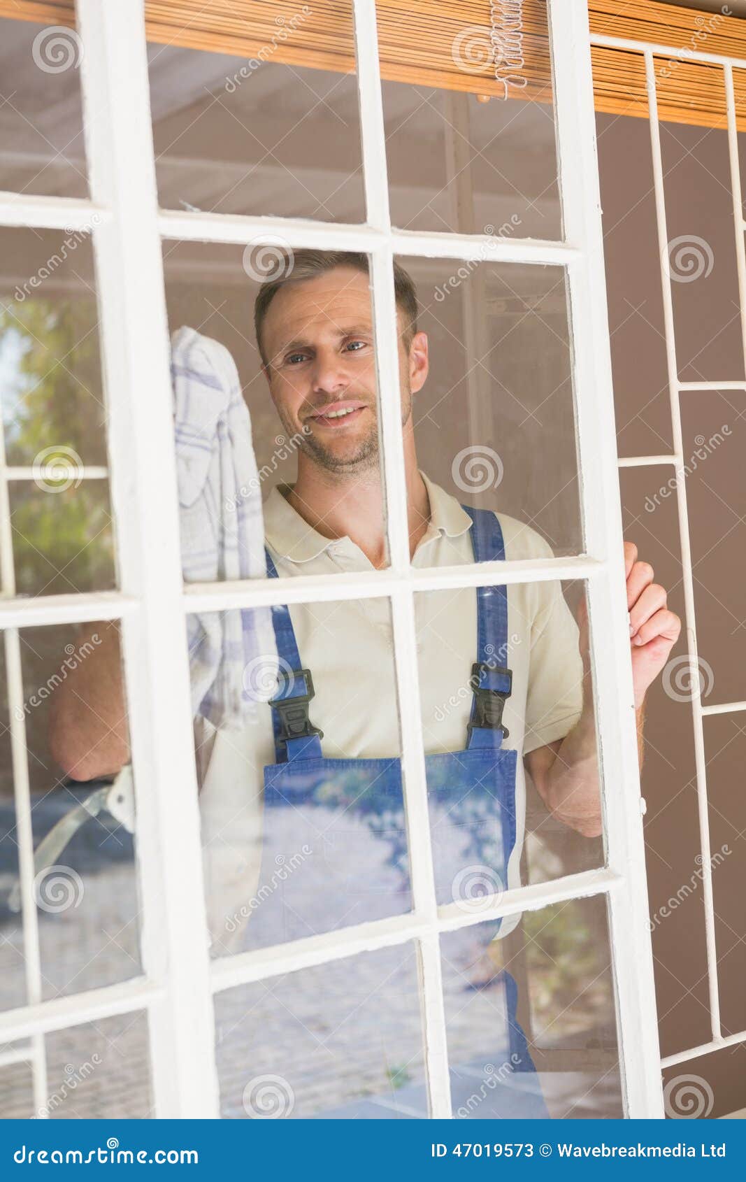 Handyman Cleaning the Window and Smiling Stock Image Image of