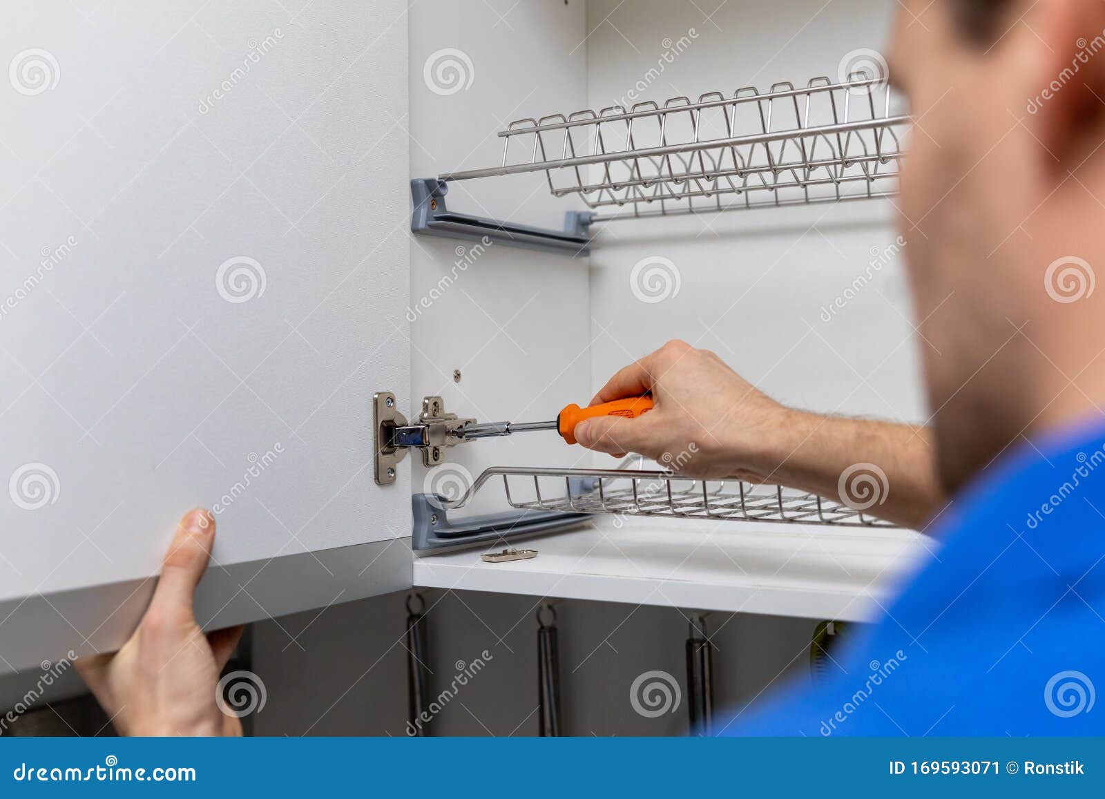 Handyman Doing Kitchen Hinge Adjustment Stock Image Image of