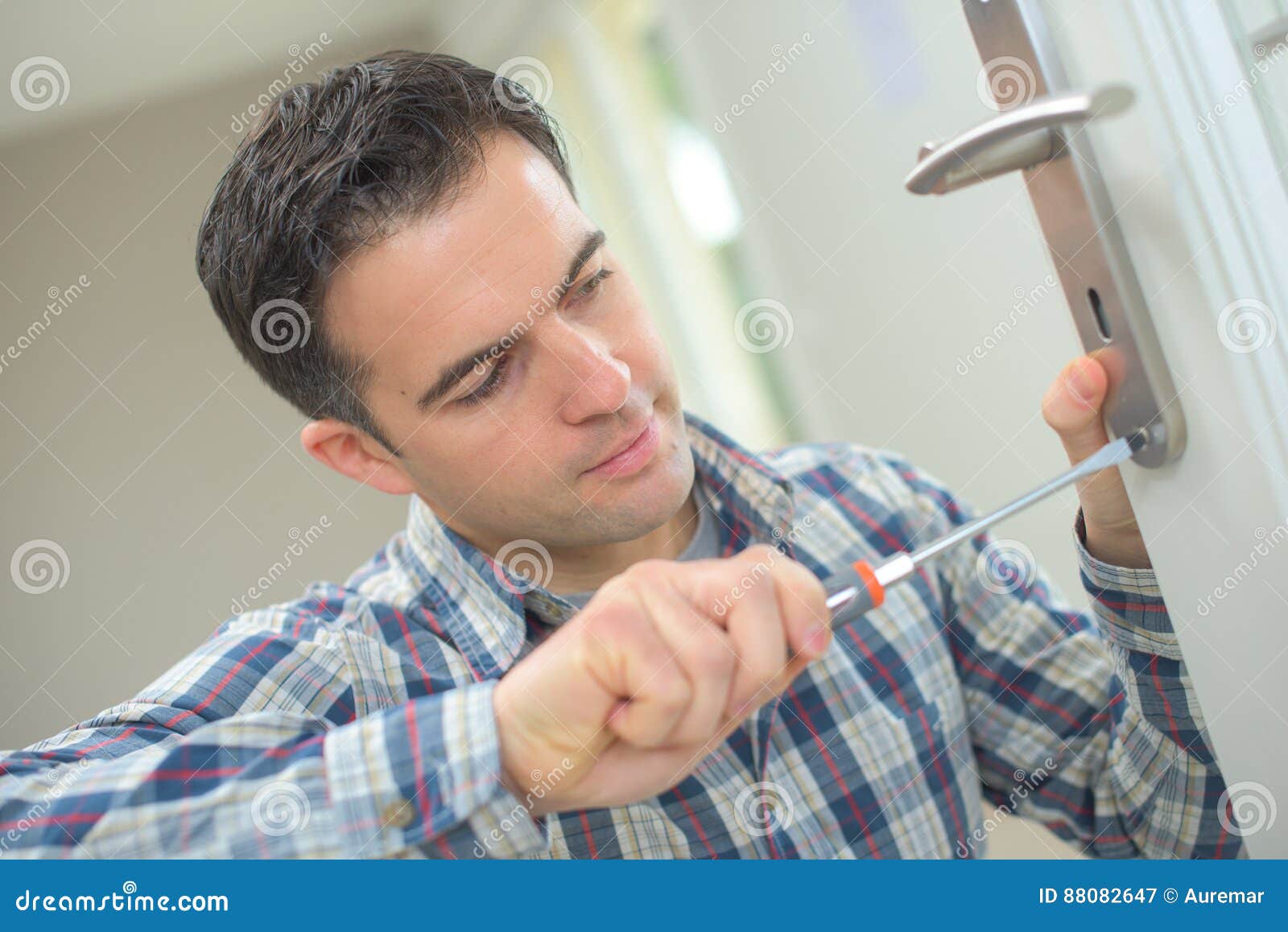 Handyman fitting new door stock image. Image of joiner 88082647