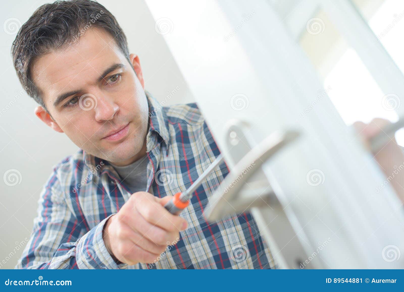 Handyman fitting new door stock image. Image of construction 89544881