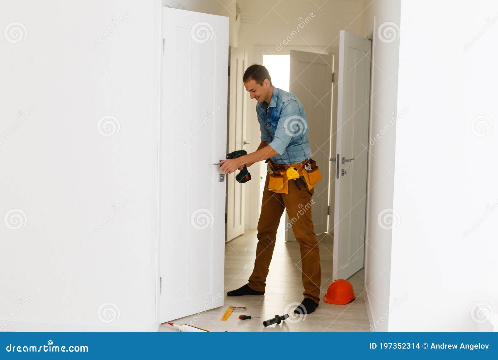 Handyman Fitting a New Door Stock Photo Image of instrument, building
