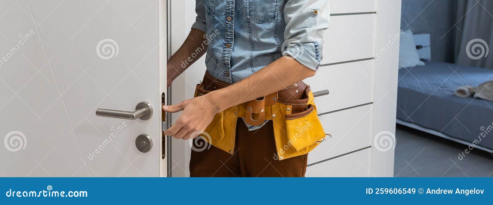 Handyman Fitting a New Door Using a Screwdriver at Home Stock Image