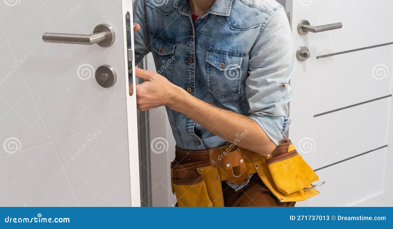 Handyman Fitting a New Door Using a Screwdriver at Home Stock Image