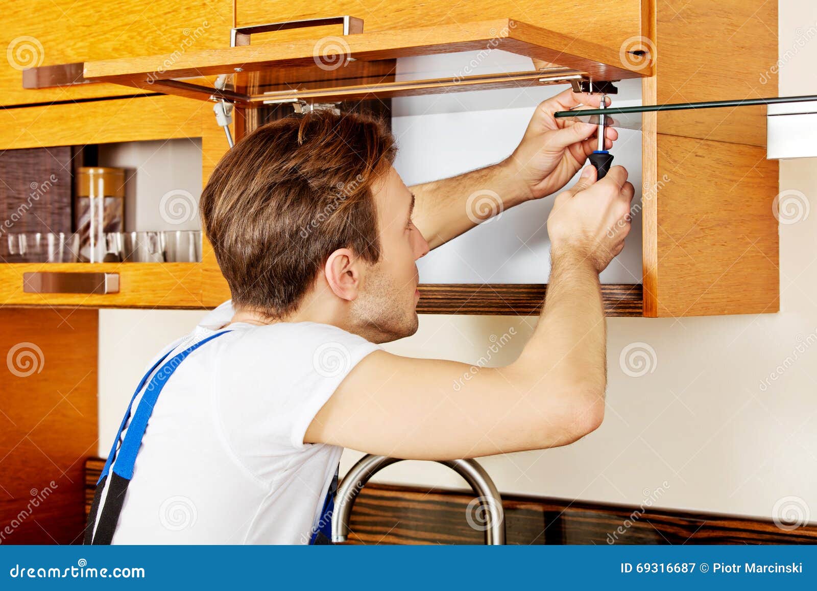 Handyman Fixing Kitchen S with Screwdriver Stock Image Image of moving, improvement
