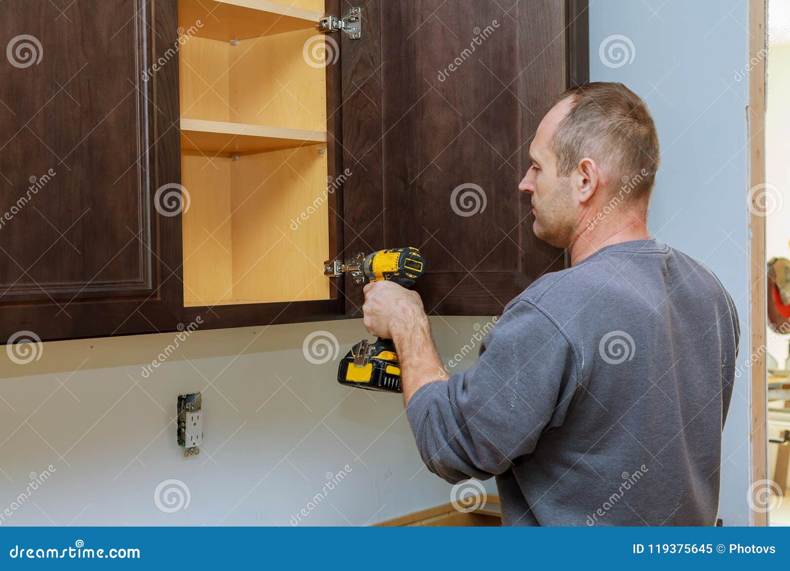 Handyman Fixing Kitchen X27 S Cabinet With Screwdriver Stock