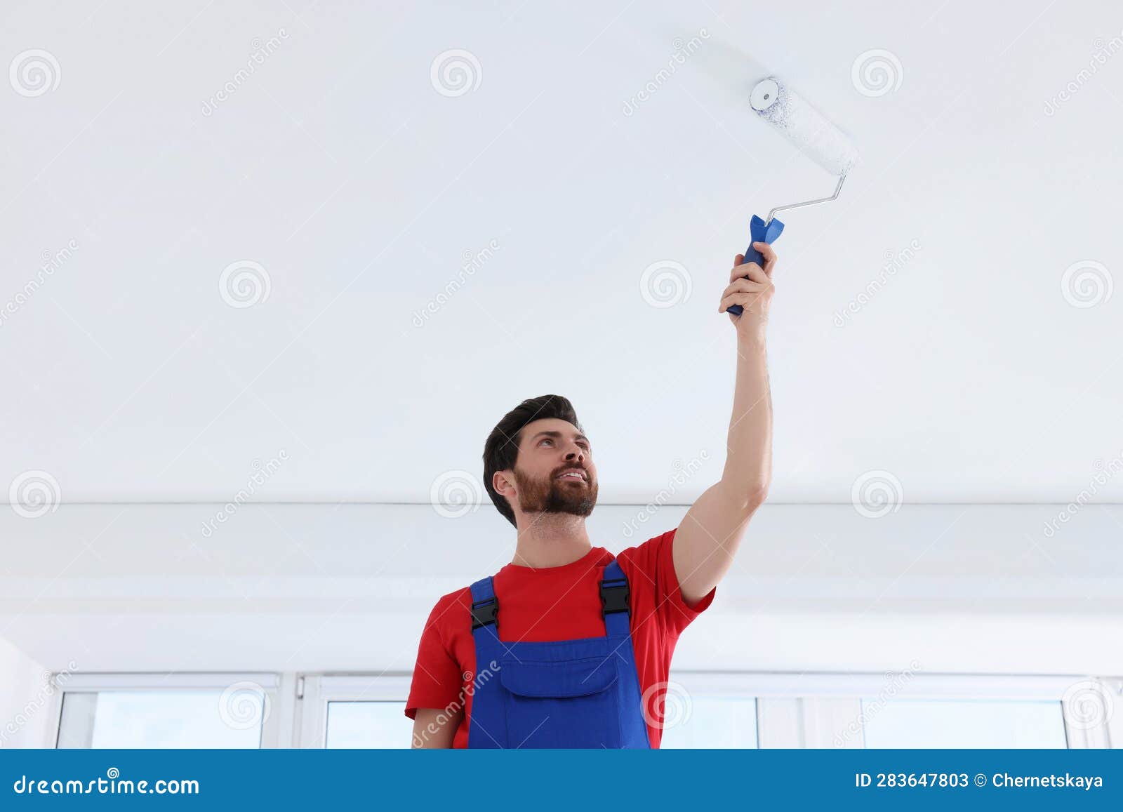 Handyman Painting Ceiling with Roller in Room Stock Image Image of