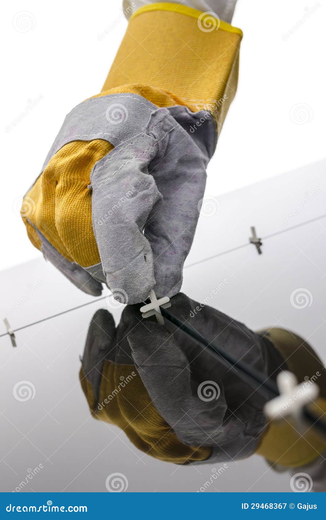 Handyman Placing Tile Spacer between Black Ceramic Tiles Stock Image