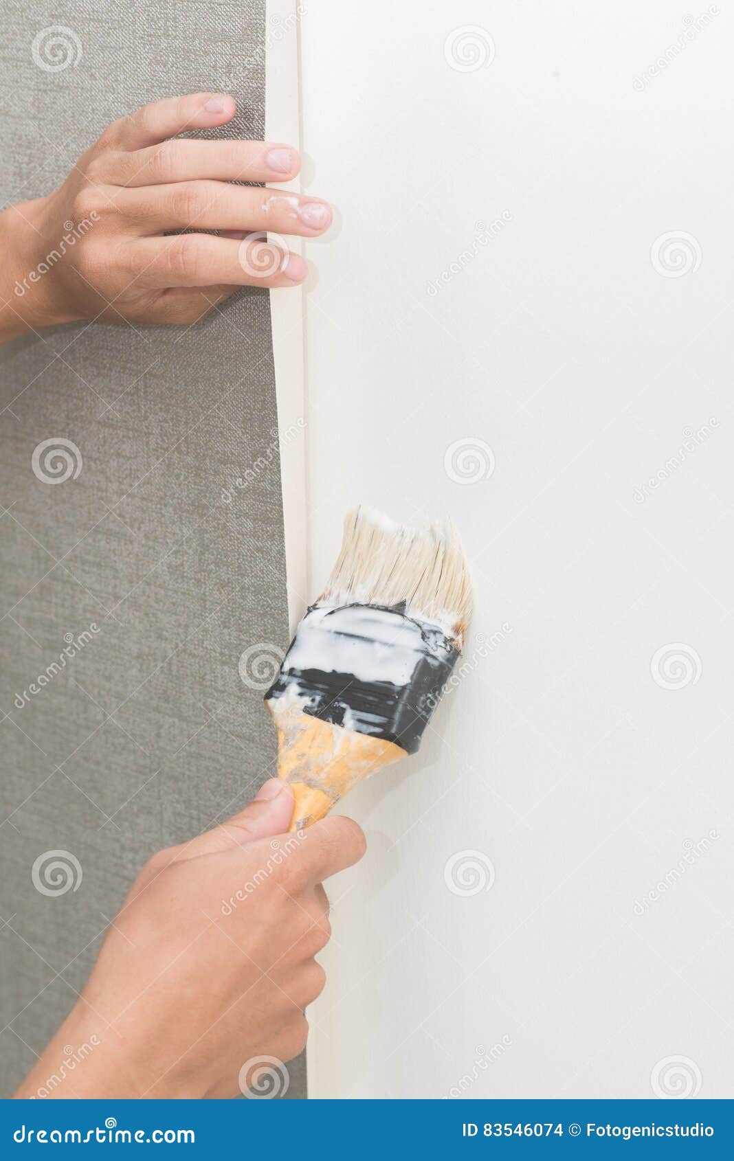 Handyman Putting Up Wallpaper on the White Wall Stock Photo Image of