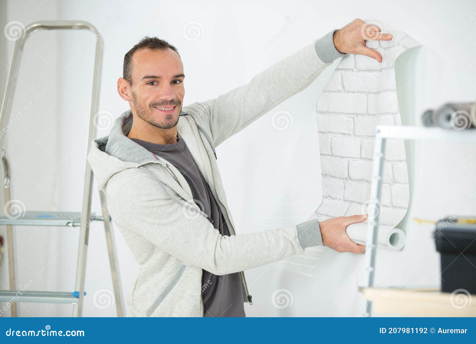 Handyman Putting Up Wallpaper on White Walls Stock Photo Image of