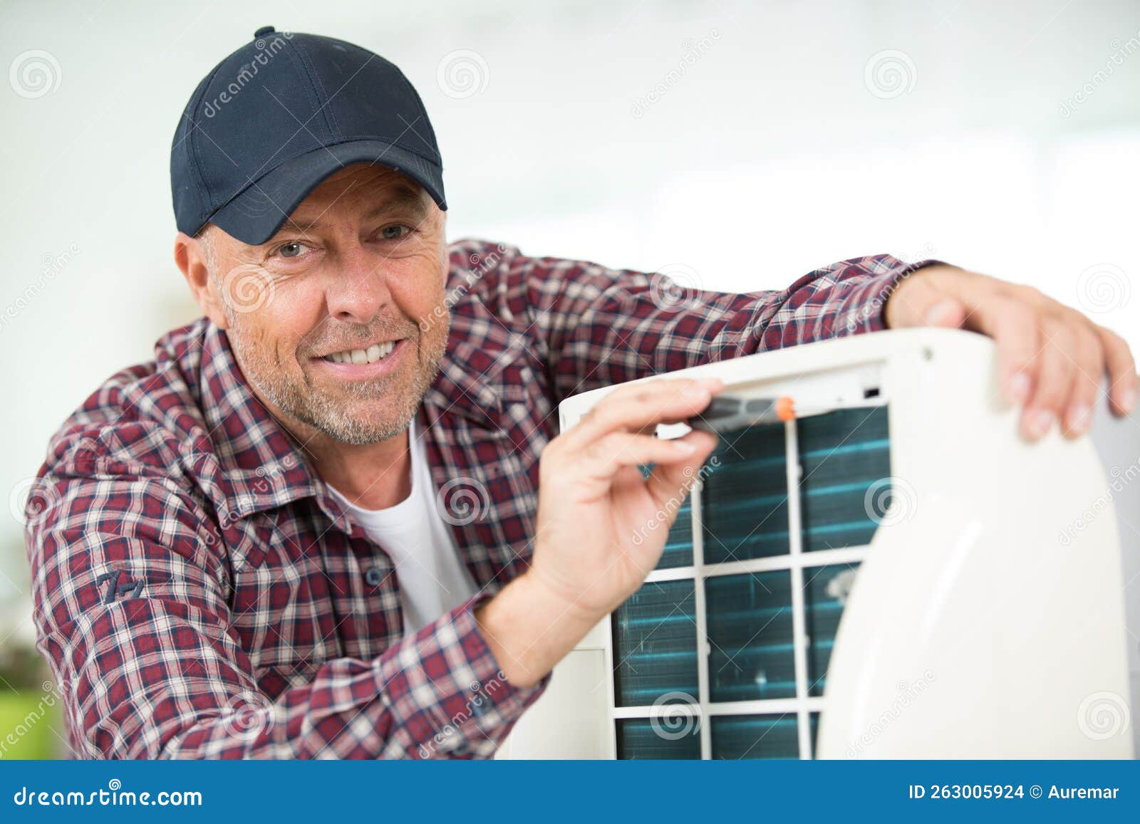Handyman Repairing Air Conditioning System Calling for Help Stock Photo