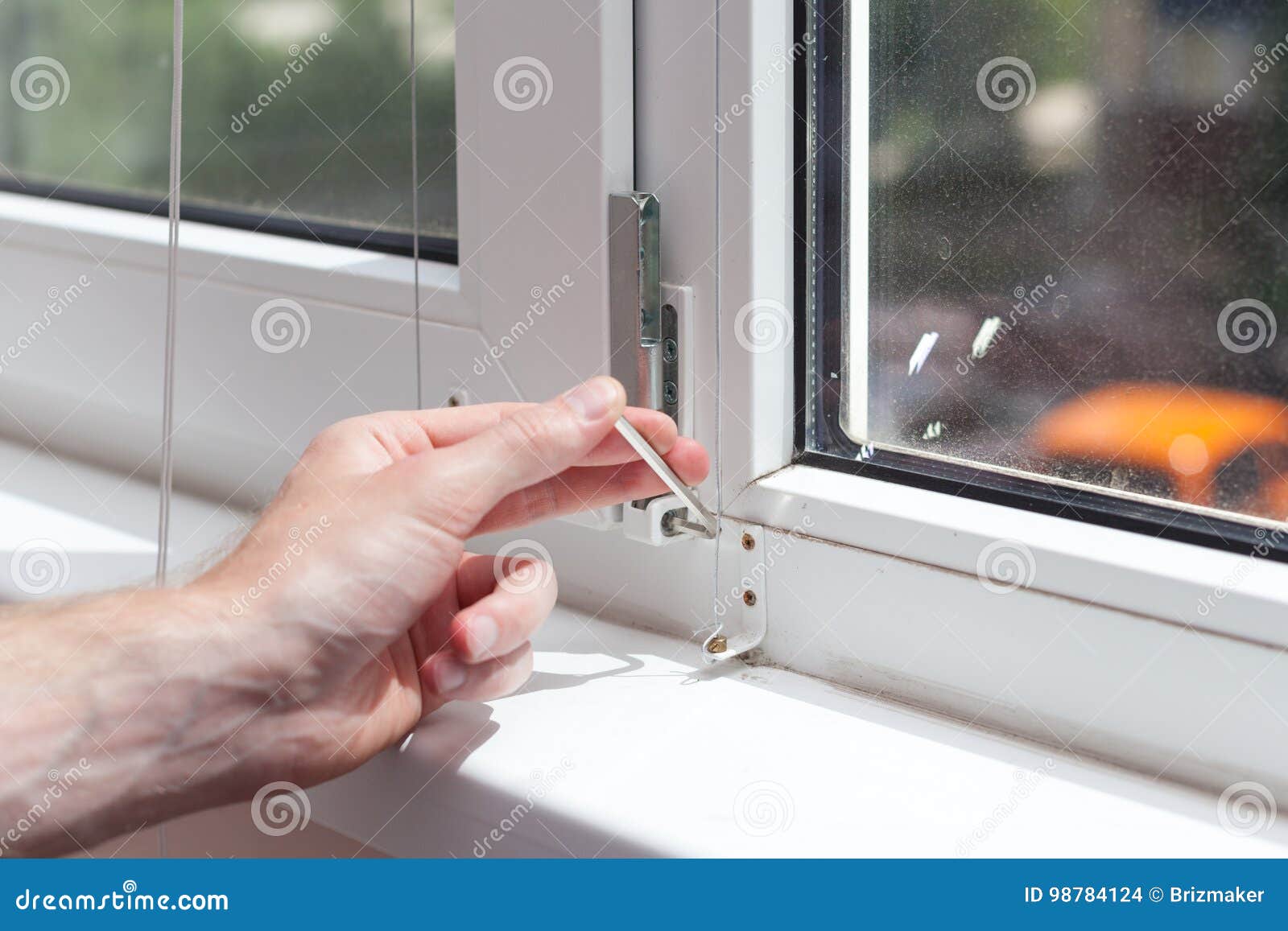 Handyman Repairs Plastic Window with a Hexagon. Workman Adjusts the