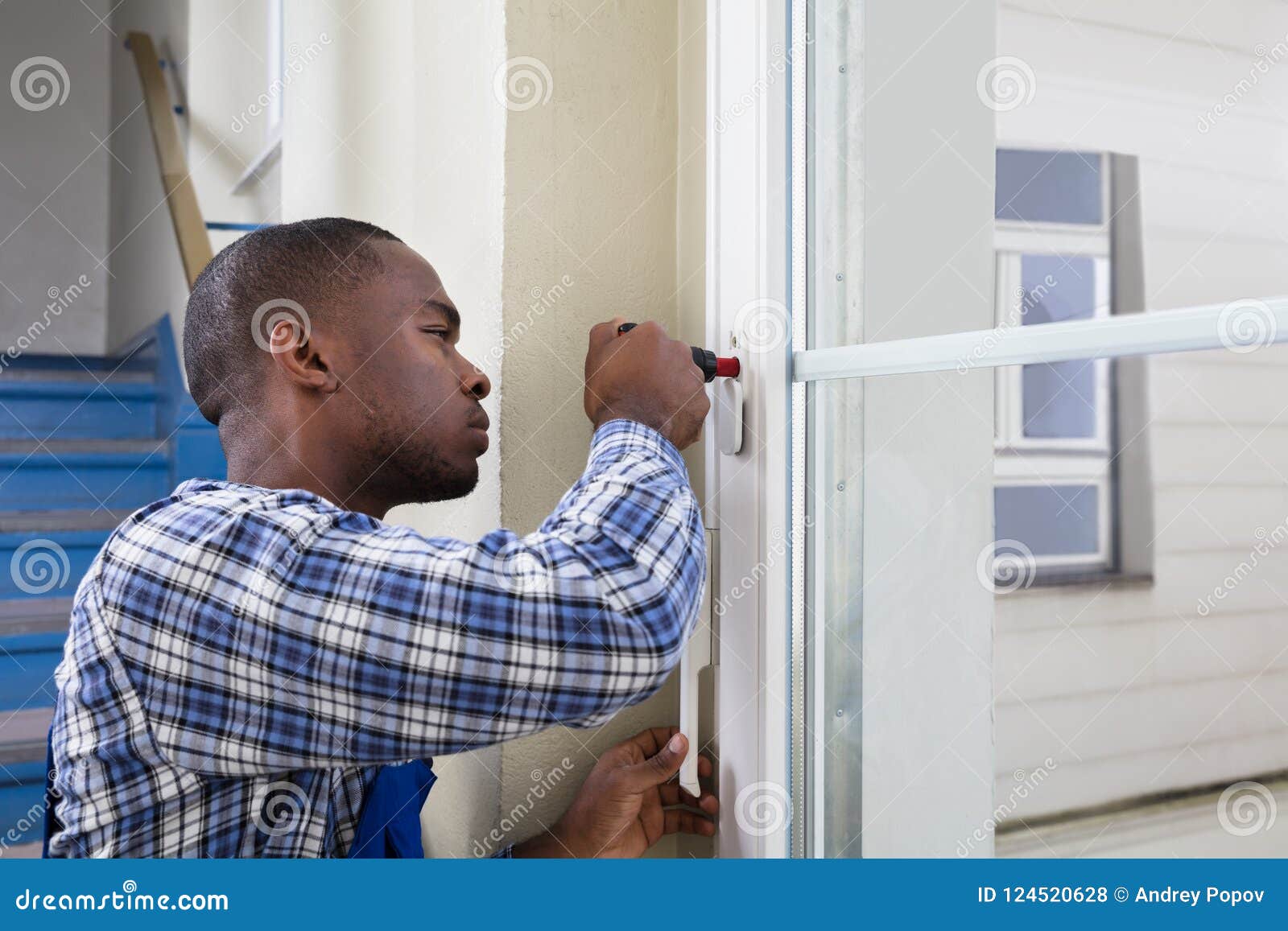 Handyman in Uniform Fixing Glass Window Stock Photo Image of fixing, close 124520628